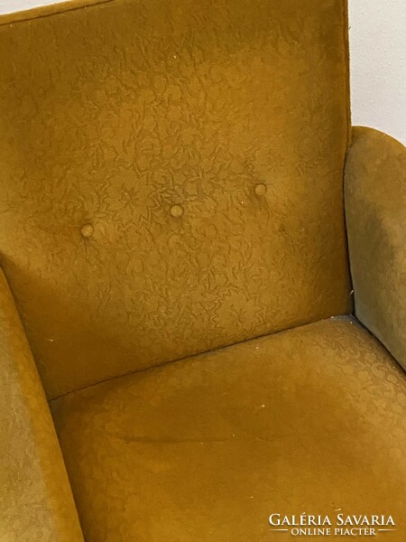 Yellow retro armchair on black iron legs