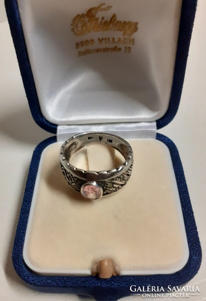 Antique hallmarked sterling silver openwork ring adorned with a polished set pink stone