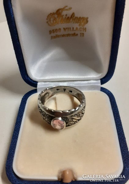Antique hallmarked sterling silver openwork ring adorned with a polished set pink stone