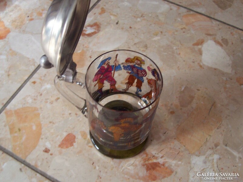 Images of medieval figures on the side of a glass jar with a lid