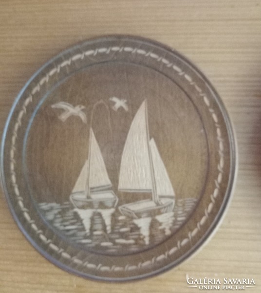 Wooden plate (3) white sailboats pyrographed on a dark background.