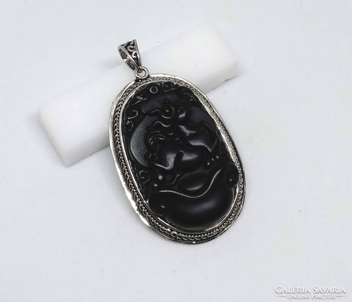 Equestrian carved black stone pendant in a silver-plated socket