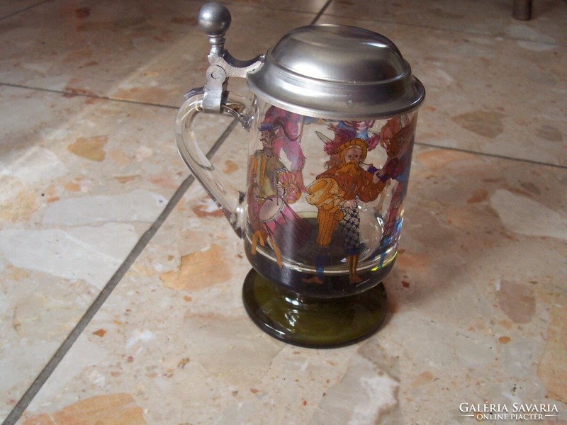 Images of medieval figures on the side of a glass jar with a lid