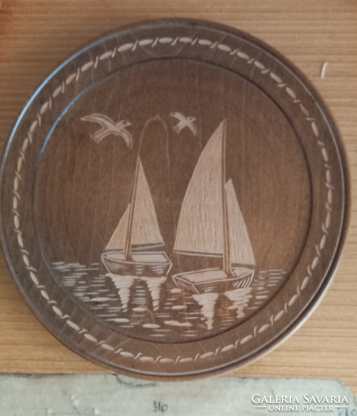 Wooden plate (3) white sailboats pyrographed on a dark background.