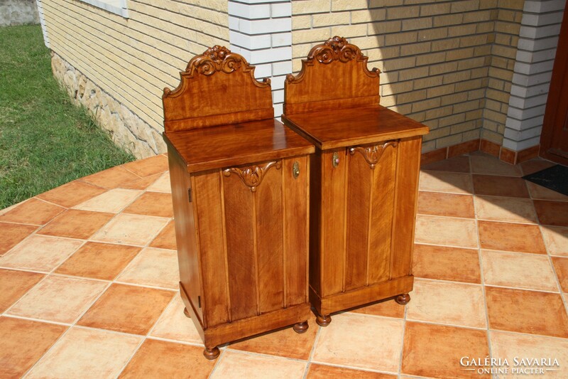 A pair of carved, built-in nightstands, left and right