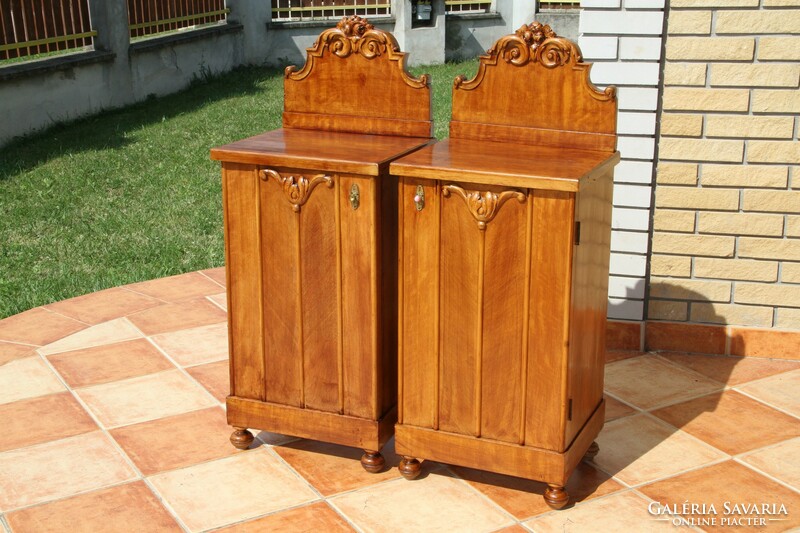 A pair of carved, built-in nightstands, left and right