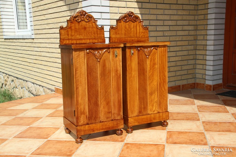 A pair of carved, built-in nightstands, left and right