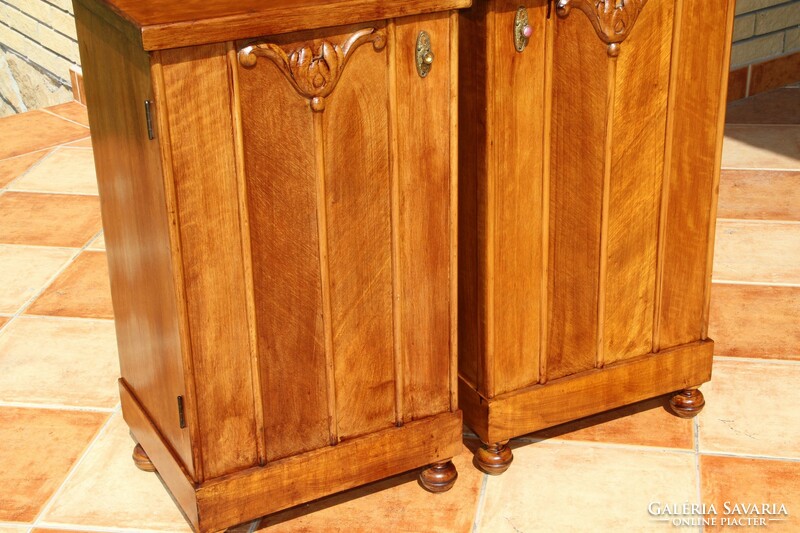 A pair of carved, built-in nightstands, left and right