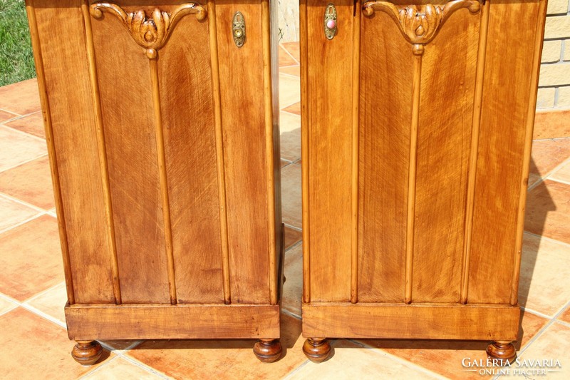 A pair of carved, built-in nightstands, left and right