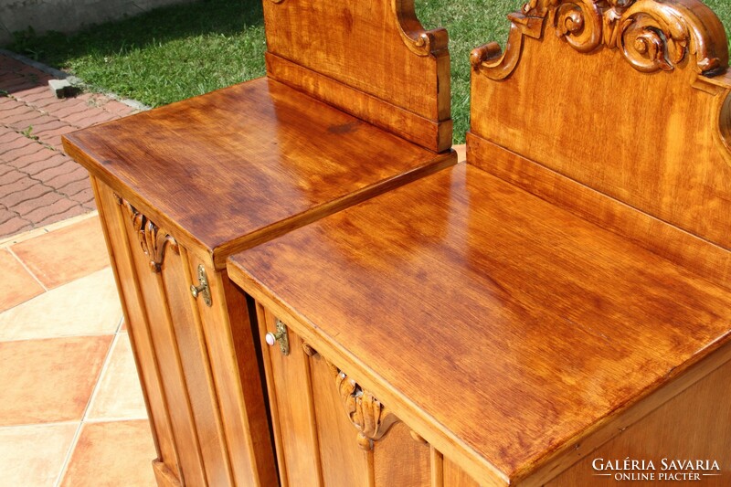 A pair of carved, built-in nightstands, left and right