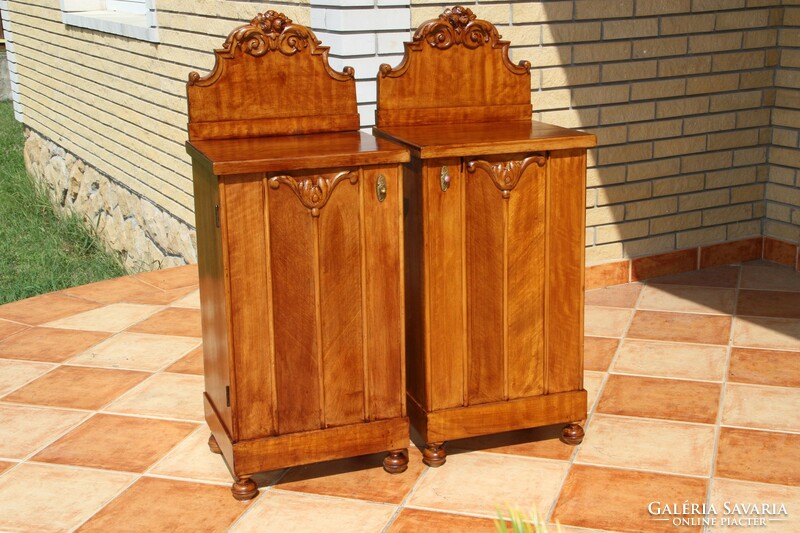 A pair of carved, built-in nightstands, left and right
