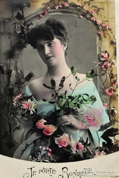 Old photo postcard of a lady with a rose