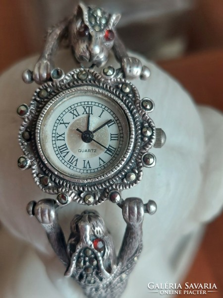 Silver watch with an animal figure