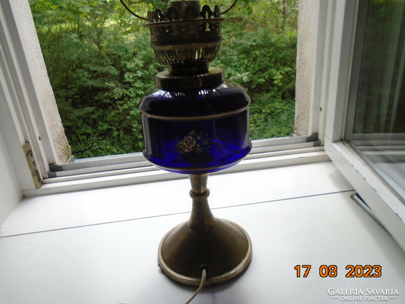 Antique hand painted flower patterned cobalt glass container with bronze colored kerosene lamp converted