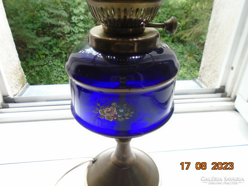 Antique hand painted flower patterned cobalt glass container with bronze colored kerosene lamp converted