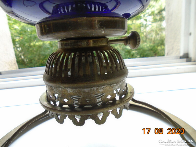 Antique hand painted flower patterned cobalt glass container with bronze colored kerosene lamp converted