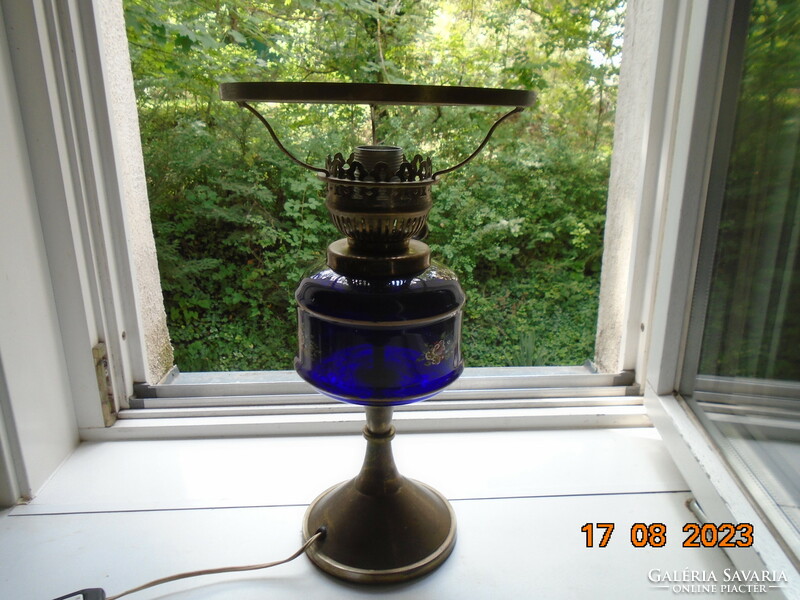Antique hand painted flower patterned cobalt glass container with bronze colored kerosene lamp converted