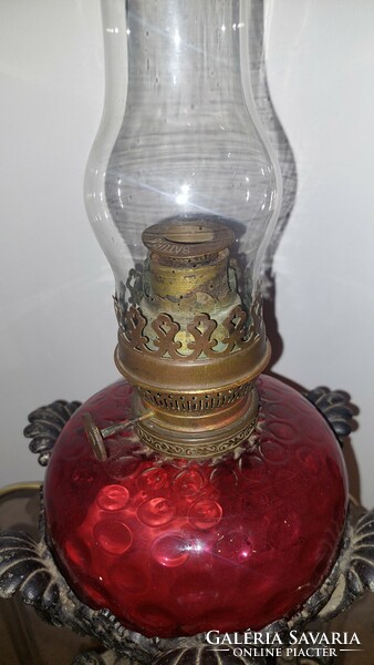 Antique kerosene lamp in crimson color with a larger glass container