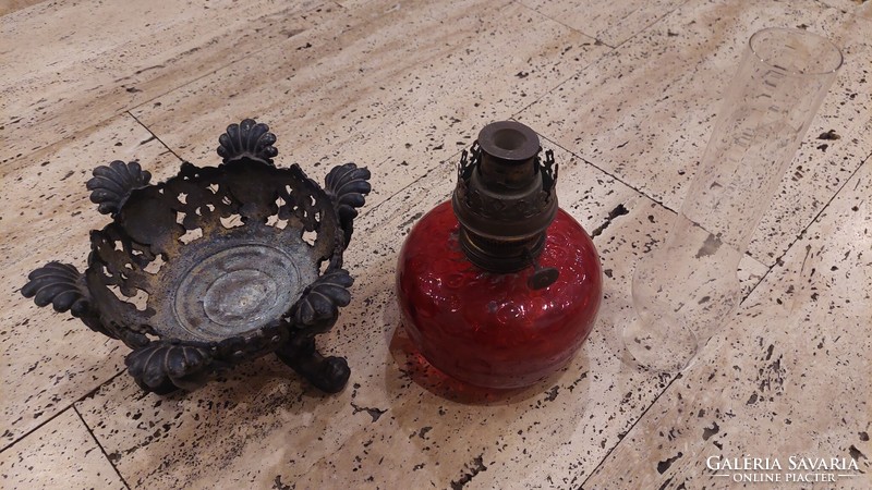 Antique kerosene lamp in crimson color with a larger glass container