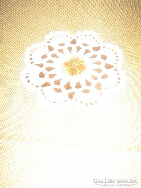Beautiful hand-crocheted tablecloth with embroidered flower inserts and fringed edges