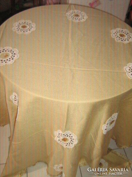 Beautiful hand-crocheted tablecloth with embroidered flower inserts and fringed edges