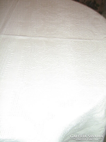 White woven tablecloth with a baroque leaf pattern in its beautiful material