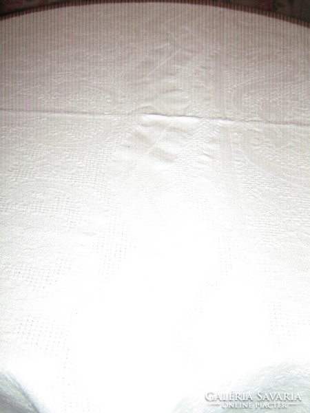 White woven tablecloth with a baroque leaf pattern in its beautiful material