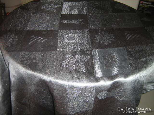 Elegant light festive tablecloth with a beautiful Christmas pattern in silvery graphite gray color