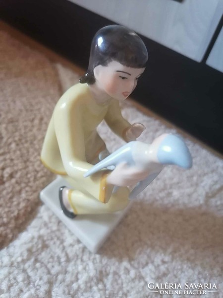 Art deco drasche figurine of a little girl playing with a porcelain doll