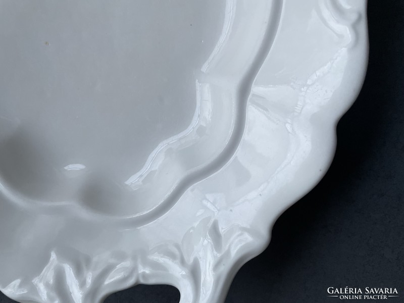 Old white porcelain serving bowl with handle, center of the table