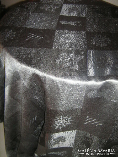 Elegant light festive tablecloth with a beautiful Christmas pattern in silvery graphite gray color