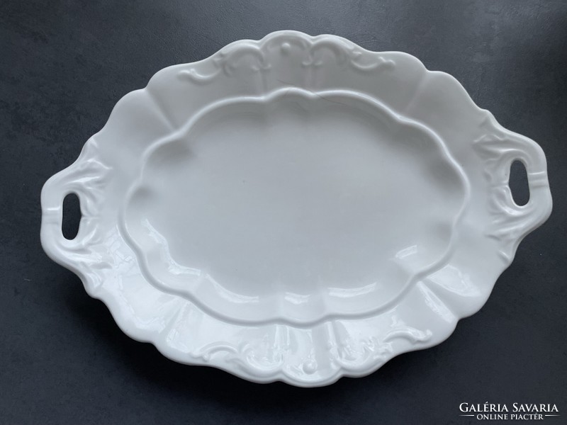 Old white porcelain serving bowl with handle, center of the table