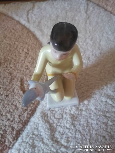 Art deco drasche figurine of a little girl playing with a porcelain doll