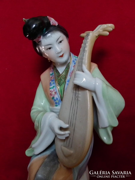 Porcelain geisha with plucked instrument 20.5 cm