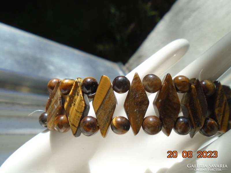 A bracelet made of polished faceted flat rhombus and spherical tiger eye pearls with high quality work
