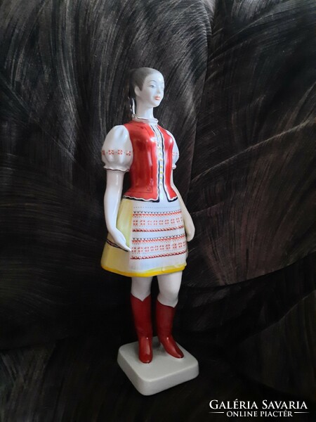 Girl in folk costume in raven house