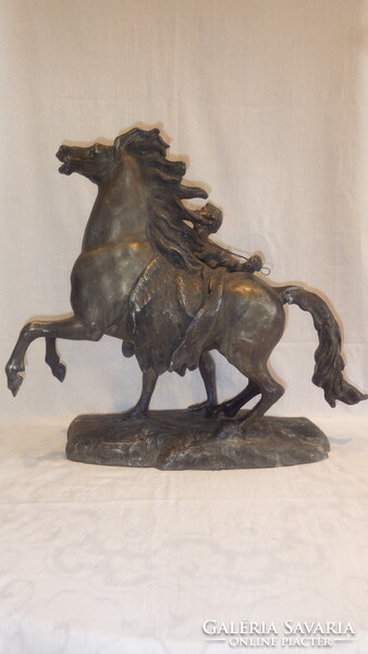 Antique large statue of a man braking his horse