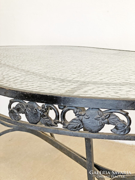 Graceful wrought iron dining table with glass top