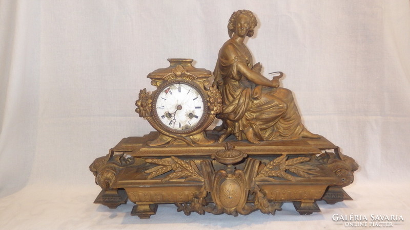 Antique fireplace clock with woman statue