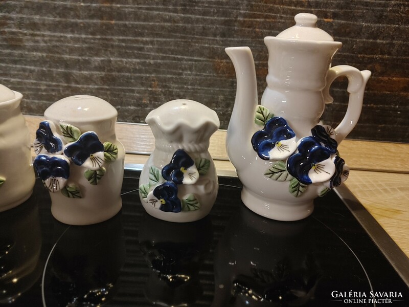 Showy blue pansy spice napkin and oil holders made of porcelain