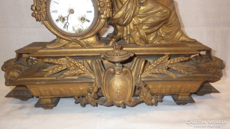 Antique fireplace clock with woman statue