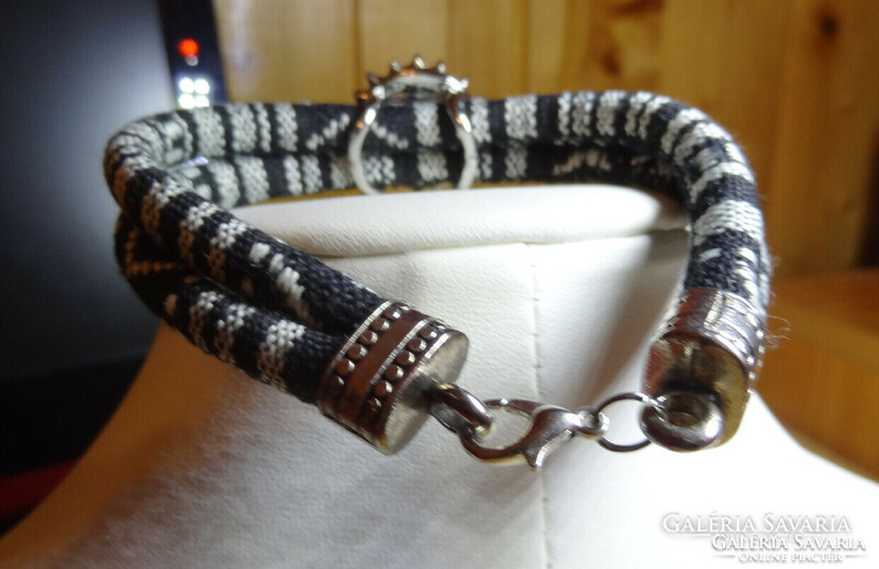 Noosa bracelet made of black and white paracord cord, with matching crystal clasp.