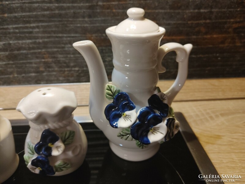 Showy blue pansy spice napkin and oil holders made of porcelain