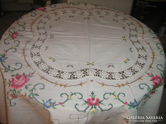 Dreamy pink oval tablecloth embroidered with small cross stitches