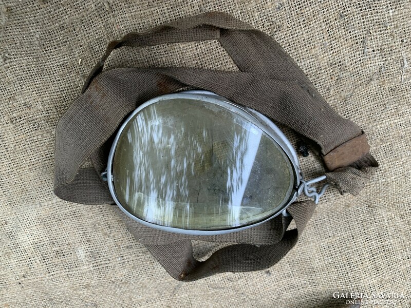 Old motorcycle pilot glasses may be warlike, showing military markings on a helmet