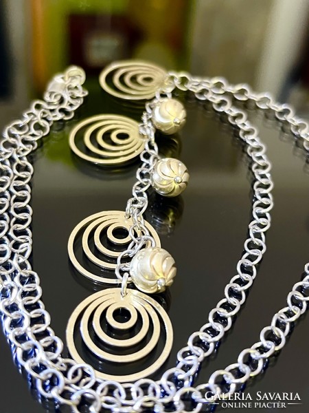 A beautiful silver necklace with a gold-plated pendant