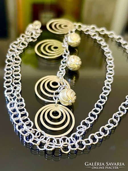 A beautiful silver necklace with a gold-plated pendant