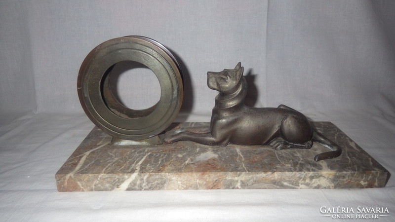 Clocks with a dog statue on a marble base