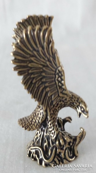 Miniature brass figure of a flying eagle catching a snake