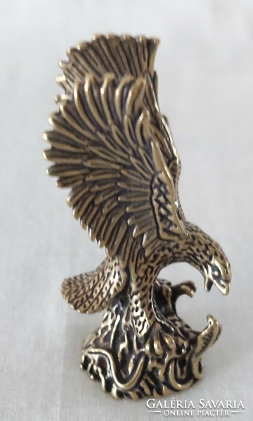 Miniature brass figure of a flying eagle catching a snake